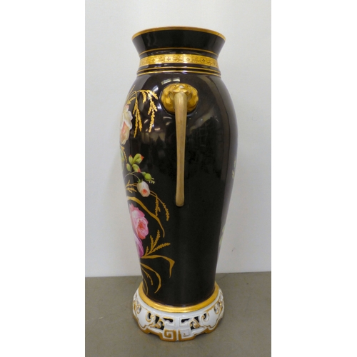 163 - A late Victorian porcelain vase with opposing mask handles, decorated with roses  17