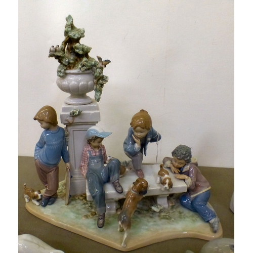 103 - Lladro china figures: to include a figure group, depicting children and puppies&nbsp; 15