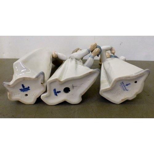 103 - Lladro china figures: to include a figure group, depicting children and puppies&nbsp; 15