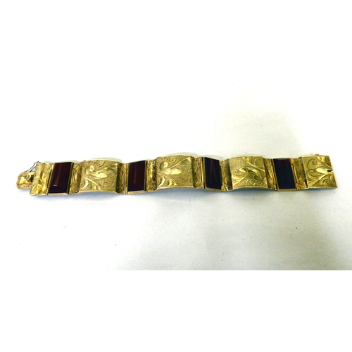 111 - A yellow metal and red tablet set, hinged bracelet&nbsp; (approx. 26grms)&nbsp;