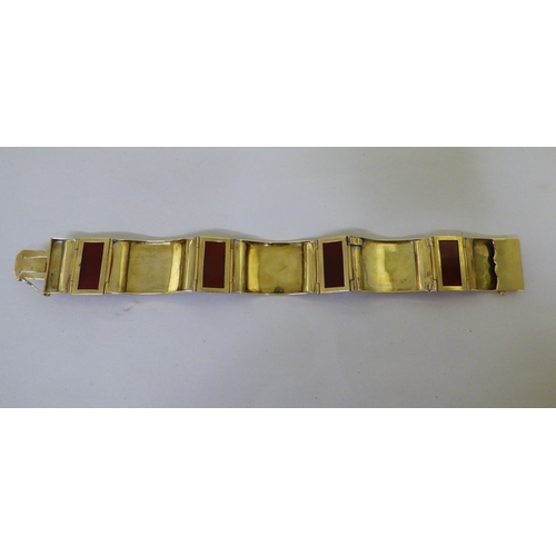 111 - A yellow metal and red tablet set, hinged bracelet&nbsp; (approx. 26grms)&nbsp;