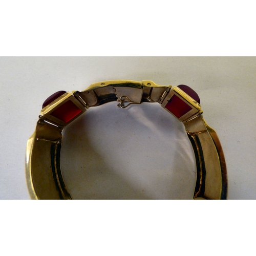 111 - A yellow metal and red tablet set, hinged bracelet&nbsp; (approx. 26grms)&nbsp;