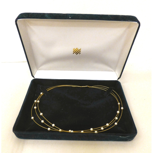 112 - A yellow metal triple wire and pearl set necklace&nbsp; (approx. 6grms)&nbsp;
