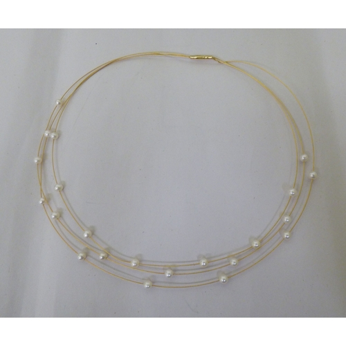 112 - A yellow metal triple wire and pearl set necklace&nbsp; (approx. 6grms)&nbsp;