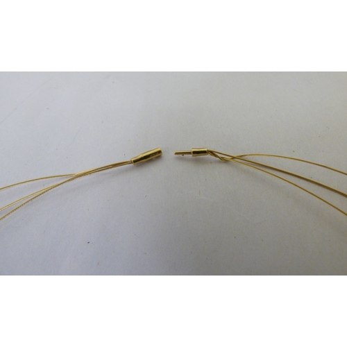 112 - A yellow metal triple wire and pearl set necklace&nbsp; (approx. 6grms)&nbsp;