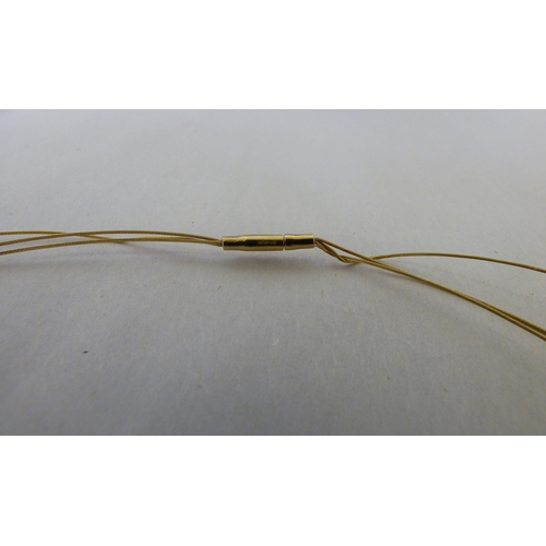 112 - A yellow metal triple wire and pearl set necklace&nbsp; (approx. 6grms)&nbsp;