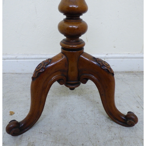 174 - A William IV mahogany polescreen with a height adjustable tapestry panel, raised on a tripod base  5... 