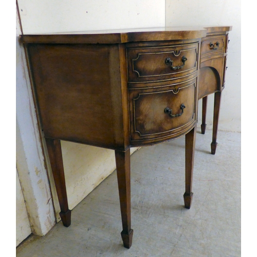 177 - A mid 20thC mahogany finished serpentine front sideboard, comprising an arrangement of drawers and c... 