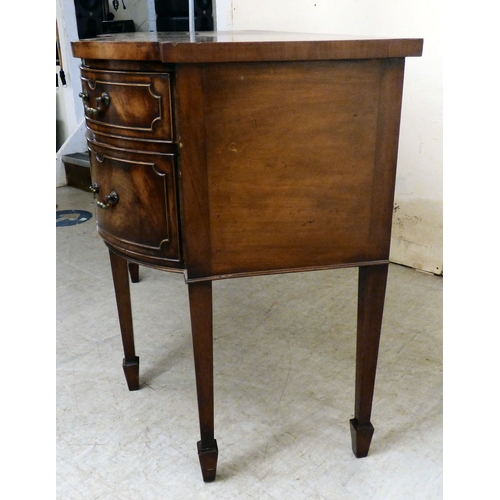177 - A mid 20thC mahogany finished serpentine front sideboard, comprising an arrangement of drawers and c... 