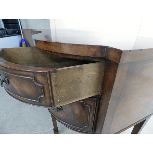 177 - A mid 20thC mahogany finished serpentine front sideboard, comprising an arrangement of drawers and c... 