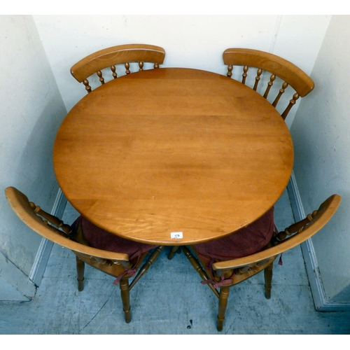 179 - A modern stained beech breakfast table, the top raised on a tripod base; and four matching chairs  3... 