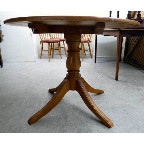 179 - A modern stained beech breakfast table, the top raised on a tripod base; and four matching chairs  3... 