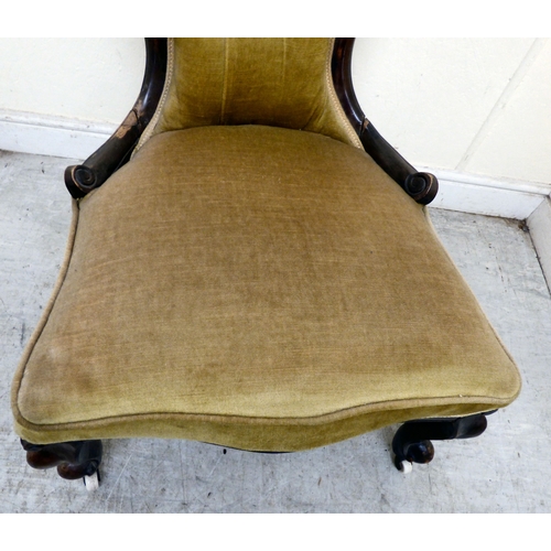 180 - A late 19thC walnut framed salon chair with a button upholstered back and seat, raised on cabriole l... 