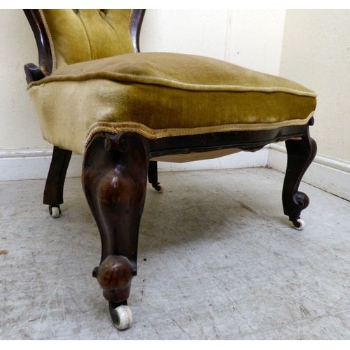 180 - A late 19thC walnut framed salon chair with a button upholstered back and seat, raised on cabriole l... 