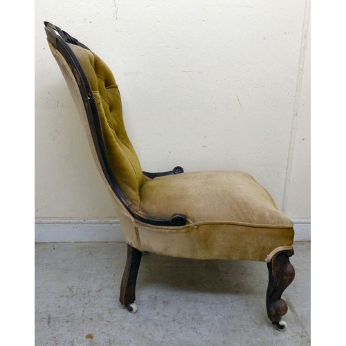 180 - A late 19thC walnut framed salon chair with a button upholstered back and seat, raised on cabriole l... 