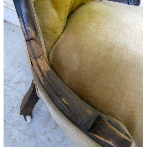 180 - A late 19thC walnut framed salon chair with a button upholstered back and seat, raised on cabriole l... 