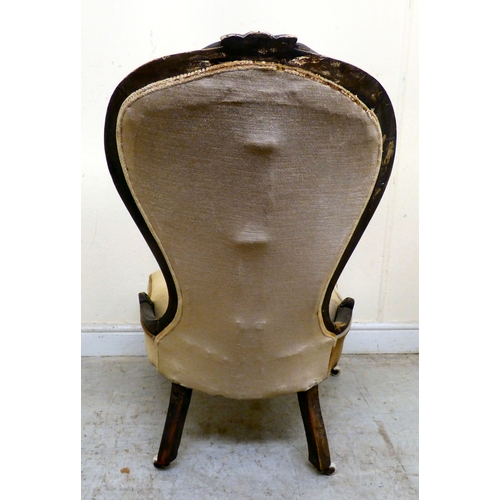 180 - A late 19thC walnut framed salon chair with a button upholstered back and seat, raised on cabriole l... 