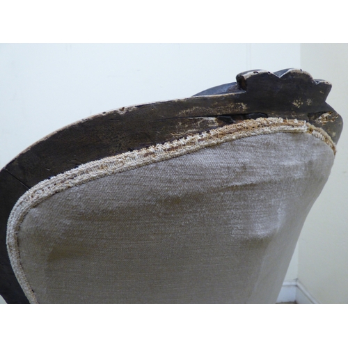 180 - A late 19thC walnut framed salon chair with a button upholstered back and seat, raised on cabriole l... 