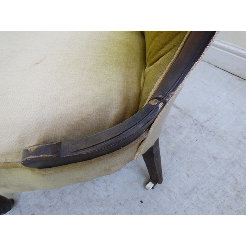 180 - A late 19thC walnut framed salon chair with a button upholstered back and seat, raised on cabriole l... 