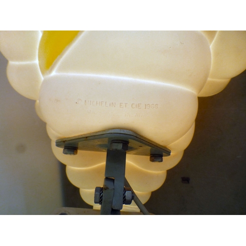 70 - A circa 1966 white plastic illuminating promotional model 'Michelin Man' on a wall bracket plinth  1... 