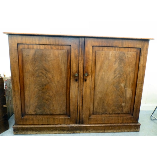 82 - A mid 19thC and later mahogany cupboard with two doors and four shelves, raised on a plinth&nbsp; 36... 