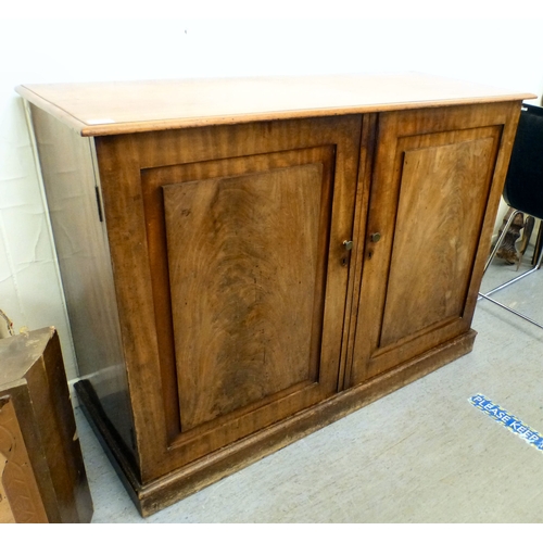 82 - A mid 19thC and later mahogany cupboard with two doors and four shelves, raised on a plinth&nbsp; 36... 