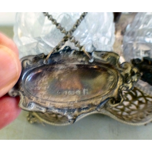 84 - An early 20thC silver plated decanter tantalus with three decanters and stoppers  bearing individual... 