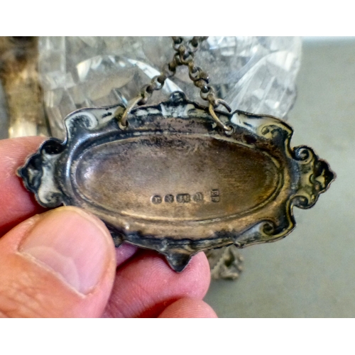 84 - An early 20thC silver plated decanter tantalus with three decanters and stoppers  bearing individual... 