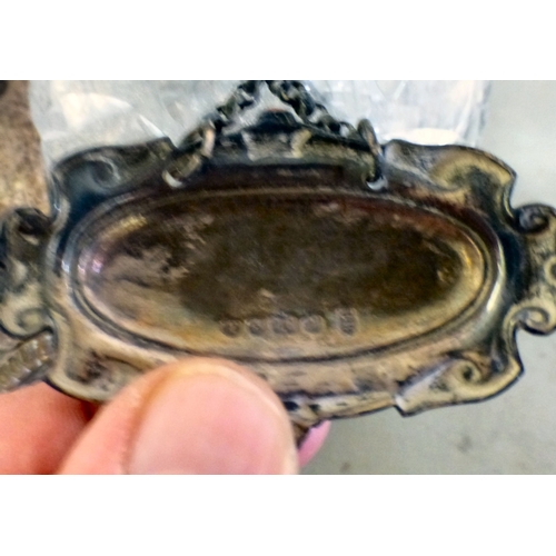 84 - An early 20thC silver plated decanter tantalus with three decanters and stoppers  bearing individual... 