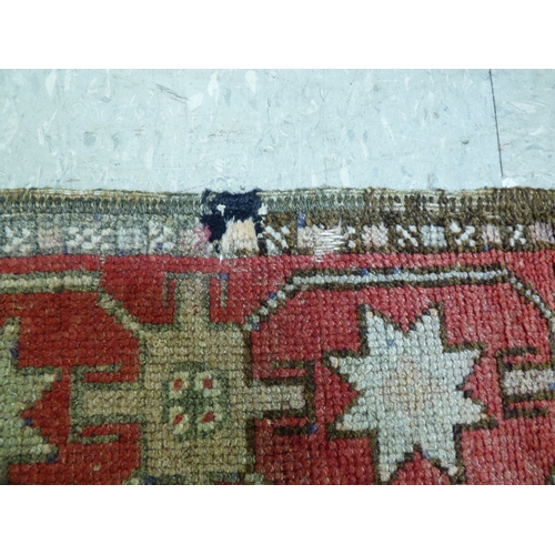 85 - A Kurdish rug, decorated with geometric and stylised designs, on a red ground&nbsp; 52