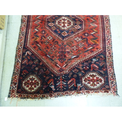 86 - A Persian rug, decorated with repeating stylised designs, on a multi-coloured ground&nbsp; 62