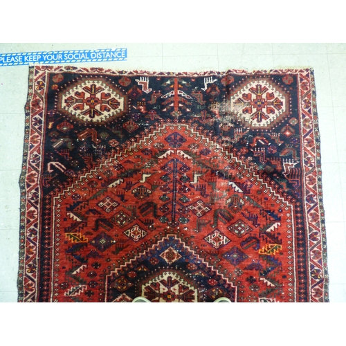 86 - A Persian rug, decorated with repeating stylised designs, on a multi-coloured ground&nbsp; 62