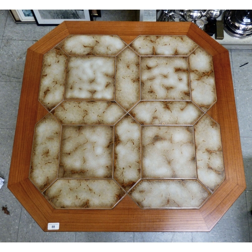 88 - A G-Plan teak framed coffee table with canted corners and tile top, raised on planked supports&nbsp;... 