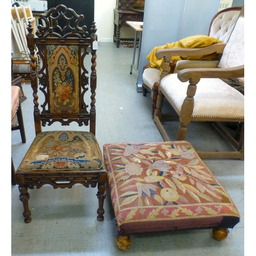 97 - A late Victorian mahogany framed tapestry upholstered nursing chair with carved decoration and barle... 