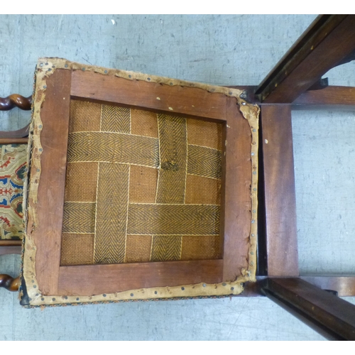 97 - A late Victorian mahogany framed tapestry upholstered nursing chair with carved decoration and barle... 