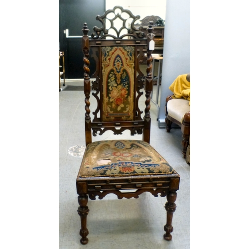 97 - A late Victorian mahogany framed tapestry upholstered nursing chair with carved decoration and barle... 
