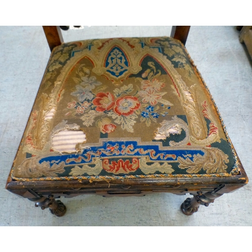 97 - A late Victorian mahogany framed tapestry upholstered nursing chair with carved decoration and barle... 