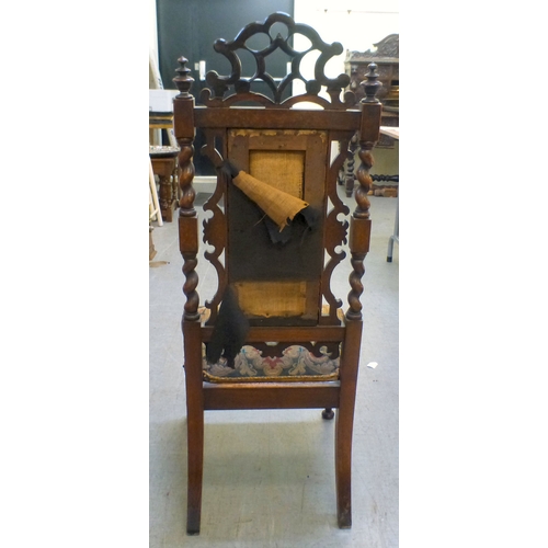 97 - A late Victorian mahogany framed tapestry upholstered nursing chair with carved decoration and barle... 