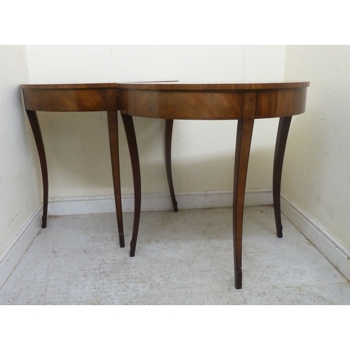 11 - A pair of modern Regency style mahogany finished demi-lune side tables, raised on sabre legs&nbsp; 3... 