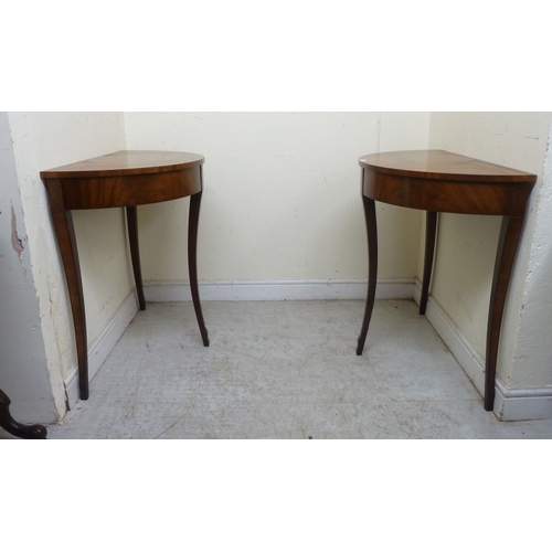 11 - A pair of modern Regency style mahogany finished demi-lune side tables, raised on sabre legs&nbsp; 3... 