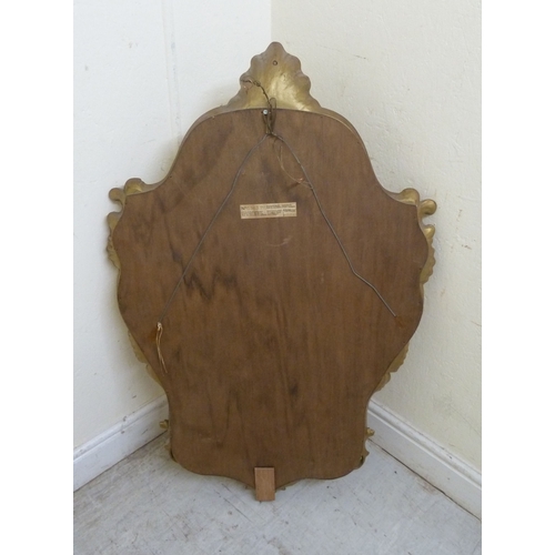 6 - A modern Continental inspired mirror, the shaped plate in a shell and C-scroll moulded gilt frame  3... 