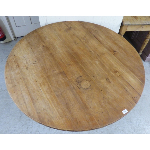 23 - A late 19th/early 20thC bleached mahogany centre table, the top raised on a grey painted pedestal an... 