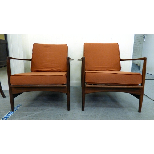 1 - A pair of IB Kofod-Larsen for G-Plan teak framed armchairs, the loose cushions upholstered in orange... 