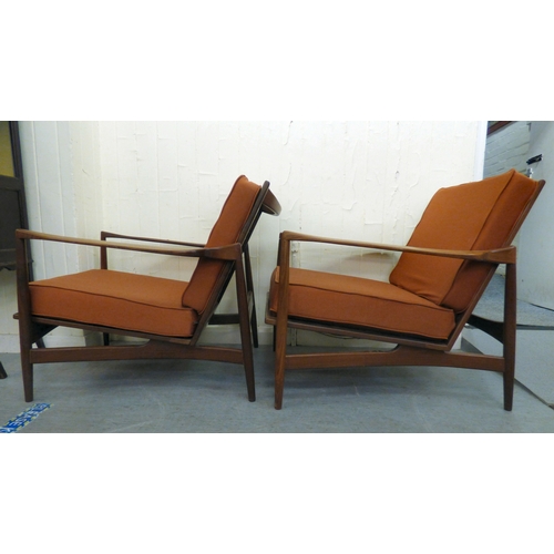 1 - A pair of IB Kofod-Larsen for G-Plan teak framed armchairs, the loose cushions upholstered in orange... 