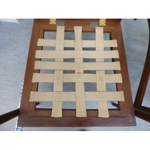 1 - A pair of IB Kofod-Larsen for G-Plan teak framed armchairs, the loose cushions upholstered in orange... 