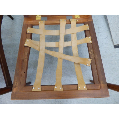 1 - A pair of IB Kofod-Larsen for G-Plan teak framed armchairs, the loose cushions upholstered in orange... 