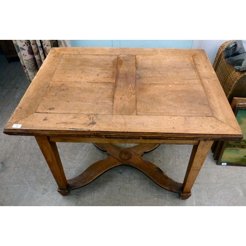 19 - A mid/late 19thC oak farmhouse style dropleaf table, raised on square, tapered legs, united by a cro... 