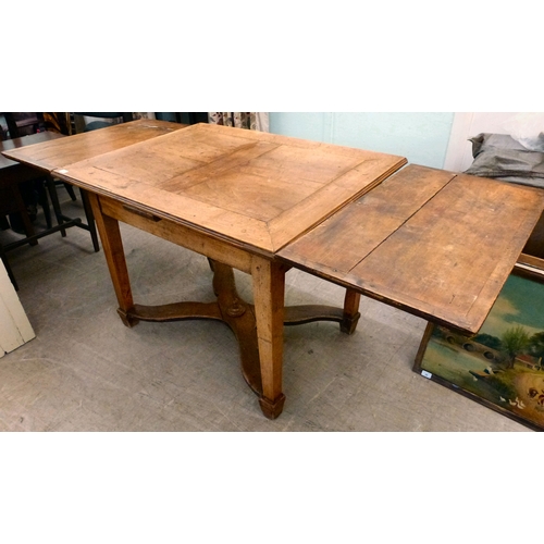 19 - A mid/late 19thC oak farmhouse style dropleaf table, raised on square, tapered legs, united by a cro... 