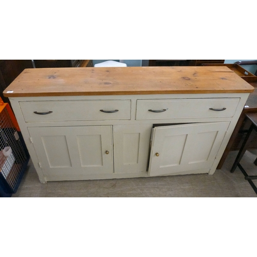 20 - A late 19thC and later cream painted wooden sideboard, the showwood pine surface over two drawers/tw... 