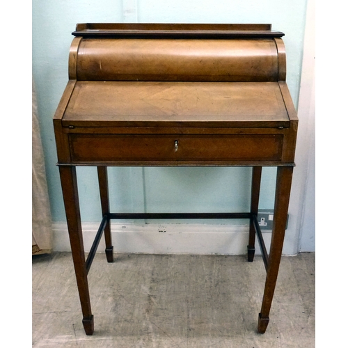 24 - An early 20thC string inlaid walnut finished roll top writing desk with a part-fitted interior, rais... 